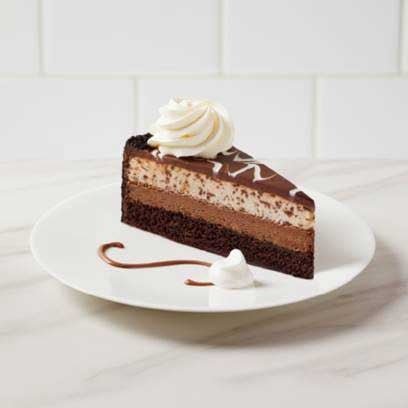 Slice of layered chocolate cake on a white plate.